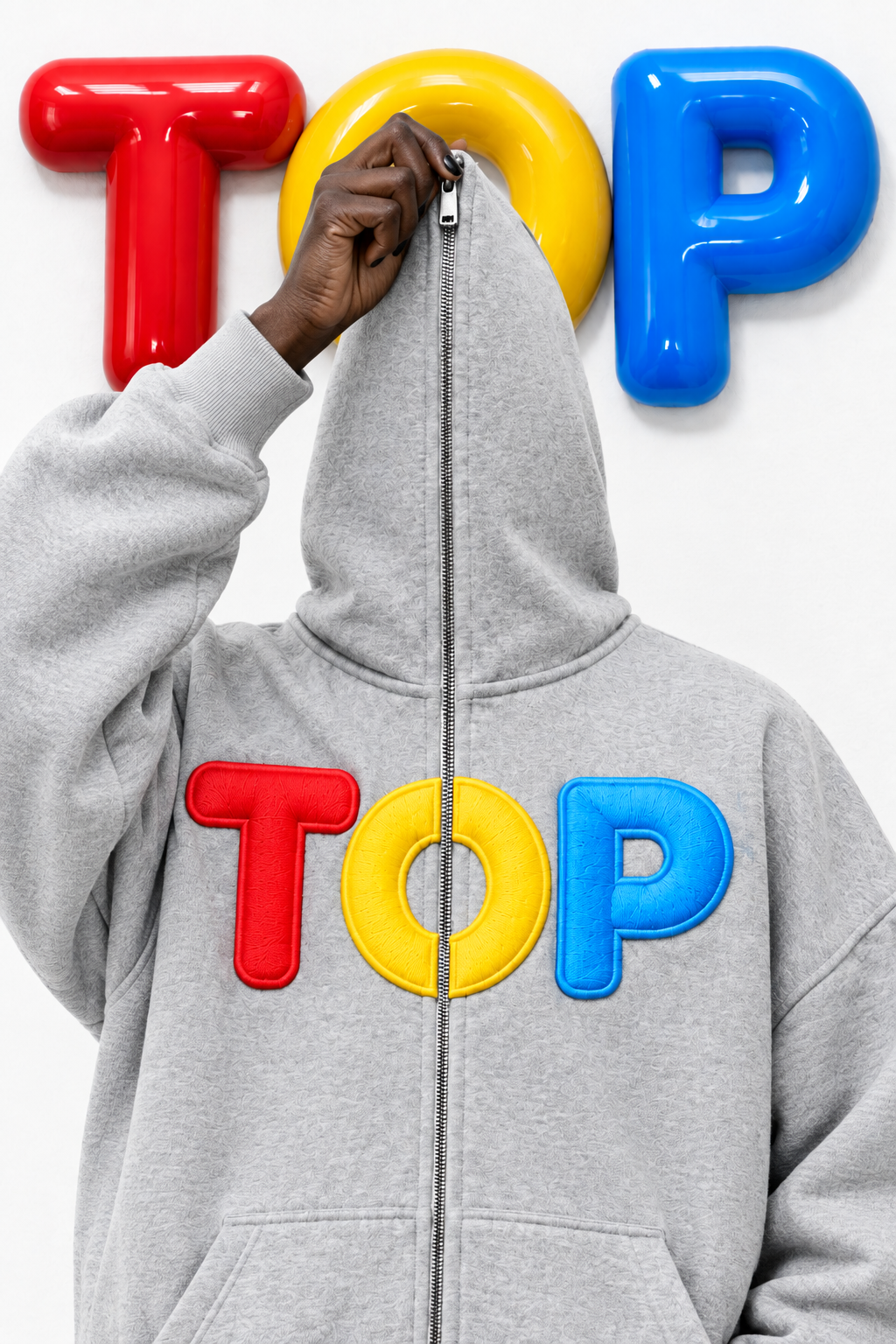 Grey TOP zip hoodie mystery shot with a hand on the zipper pull